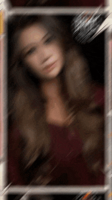 a blurry picture of a woman with long hair in a red dress