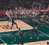 a basketball game is being played on a court sponsored by state farm .