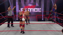 two wrestlers are in a ring with the words hardcore justice on the wall behind them