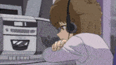 a girl wearing headphones is listening to a radio