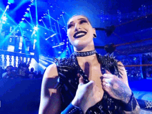 a woman in a wrestling ring with the letter w on the ring