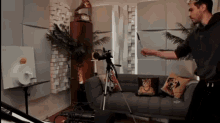 a man is standing in front of a couch in a living room