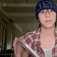 a man wearing a beanie that says fendi on it