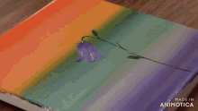 a person is painting a purple flower with a brush on a canvas made in animatica