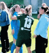 a female soccer player with the number 13 on her back