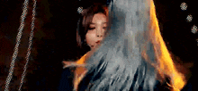 a close up of a woman 's face with smoke coming out of her hair