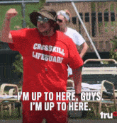 a man in a red shirt that says cross kill lifeguard on it
