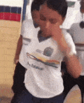 a person wearing a white shirt that says ' s. e. m. ' on it