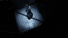 a shadow of a person is cast on a tiled floor in a dark room