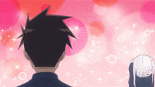 a man and a woman are looking at each other with pink circles in the background