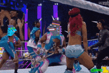 a group of people are dancing in a wrestling ring with the words sky sport live in the corner