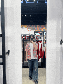 a person taking a picture of themselves in a mirror in a store