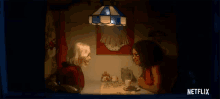 a woman sits at a table in a dark room with a netflix logo on the bottom right