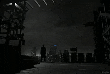 a black and white photo of a man standing on a rooftop with a prime logo in the background