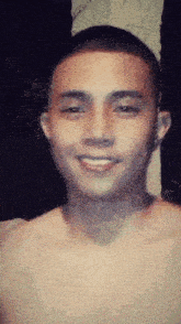 a shirtless man is smiling for the camera