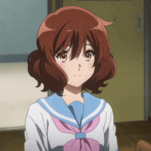 a girl with brown hair is wearing a blue and white uniform with a pink bow