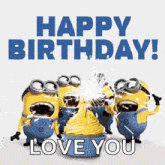 a group of minions are standing around a cupcake with a candle on it .
