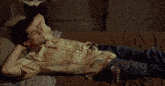 a man is laying on a bed with a can of coca cola in his lap