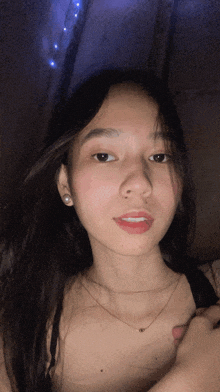 a woman with long hair is wearing a black bra