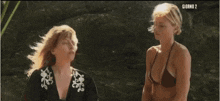 two women in bikinis are standing next to each other and the words giorno 2 are on the bottom