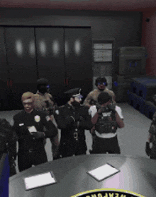 a group of police officers are standing around a table with a weapons sticker on it