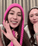 two women are posing for a picture and one has a tattoo on her wrist that says " i love you "