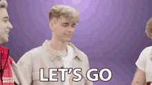 a young man says let 's go in front of a group of people