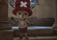 a stuffed animal with antlers and an x on its hat
