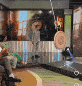 a man in a suit stands in front of a clock while a spinning object is hanging from a rope