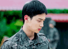 a man in a military uniform has the letters adts on his collar