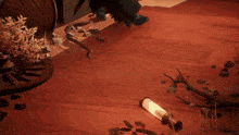a video game scene with a lantern and a barrel on the ground