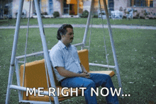 a man is sitting on a swing with the words me right now