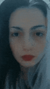 a close up of a woman 's face with red lips .