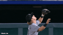 a baseball player in a white sox uniform catches the ball