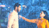 a man and a woman are standing in the rain and the word hd is on the bottom