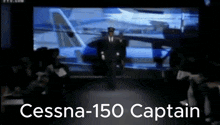 a cessna 150 captain stands on a stage in front of a crowd