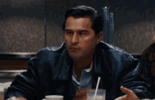 a man sitting at a table with the words " what the fuck are you talking about " above him