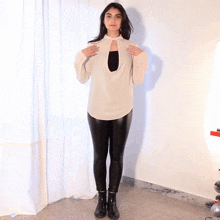 a woman wearing a white shirt and black leggings