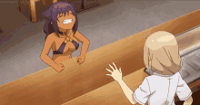 a girl in a bikini stands behind a counter with another girl