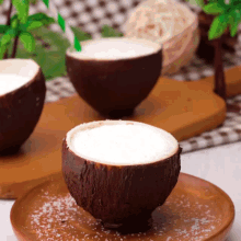 a coconut cup with a straw in it sits on a plate