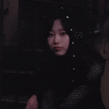a woman with long black hair and pearls in her hair