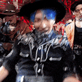 a man with blue hair and a cowboy hat is dancing