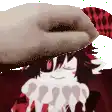 a hand is putting a hat on a girl 's head