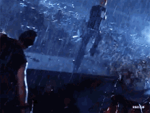 a group of people standing in the rain with rbd gif written on the bottom right