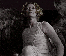 a woman in a white dress with angel wings on her back