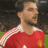 a man in a red manchester united jersey on a field
