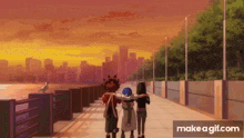 a group of people are walking down a sidewalk with a city in the background