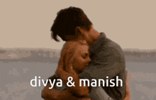 a man and a woman hugging with the words divya & manish below them