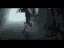 a blurred image of a person standing in a dark room with a light coming out of the corner .