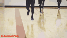 a person is running on a basketball court and the word esquire is on the bottom